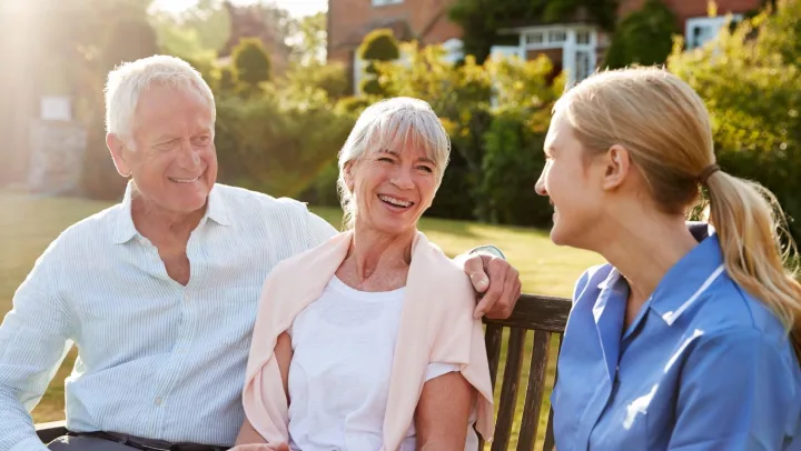 Senior couple smiling with nurse