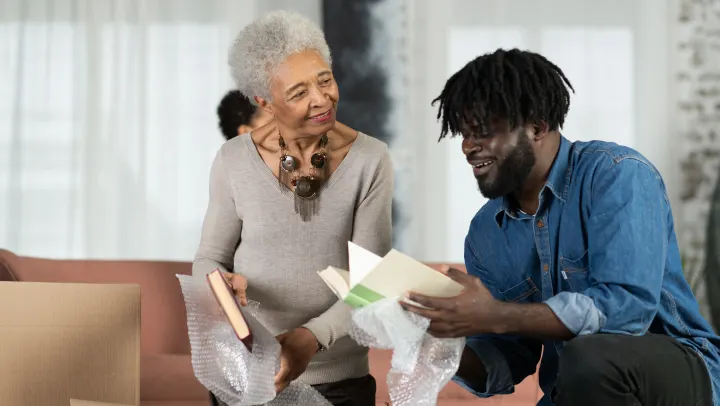 young man speaking to elderly woman